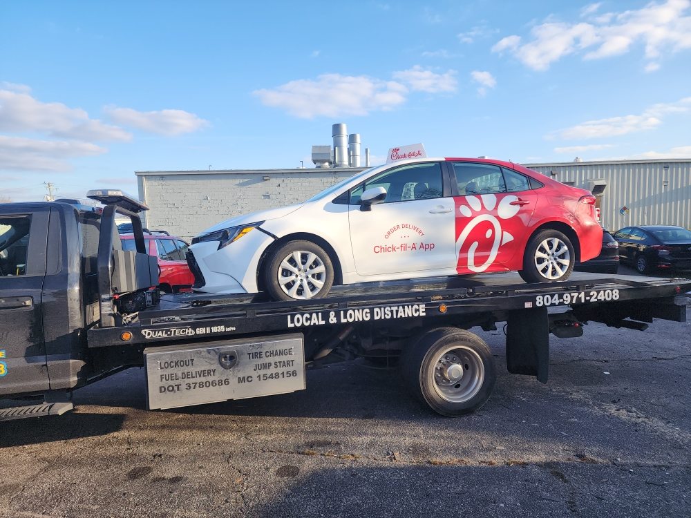 Sedan secured on a Roadrunner flatbed tow truck