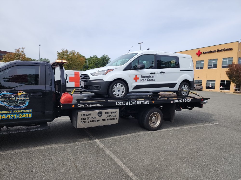 Cargo van loaded on a Roadrunner flatbed tow truck